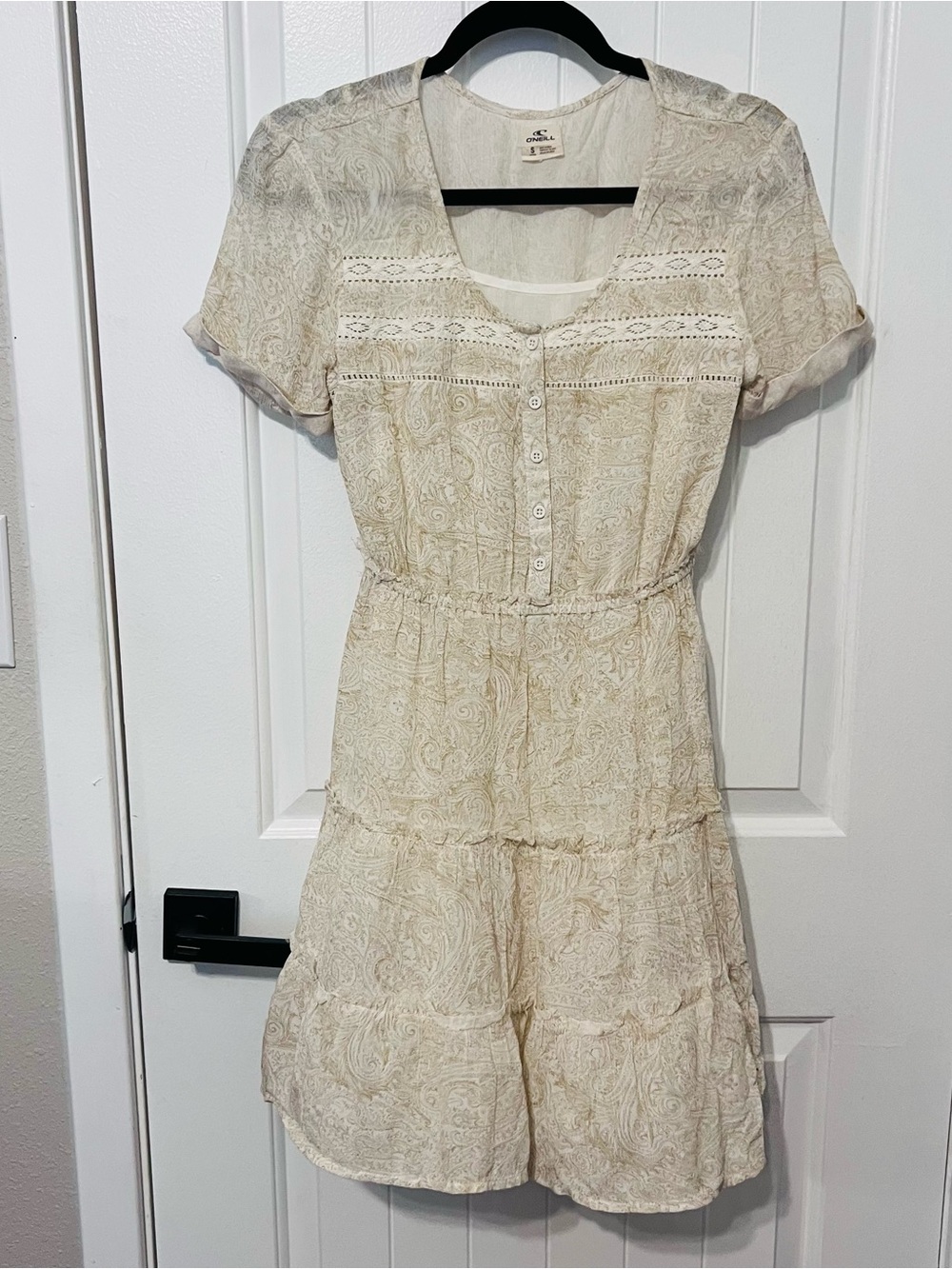 O'Neill brand tiered short-sleeve beige and white paisley patterned dress.